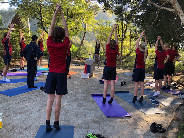 Yoga at sunrise for Year 9s in The Cove